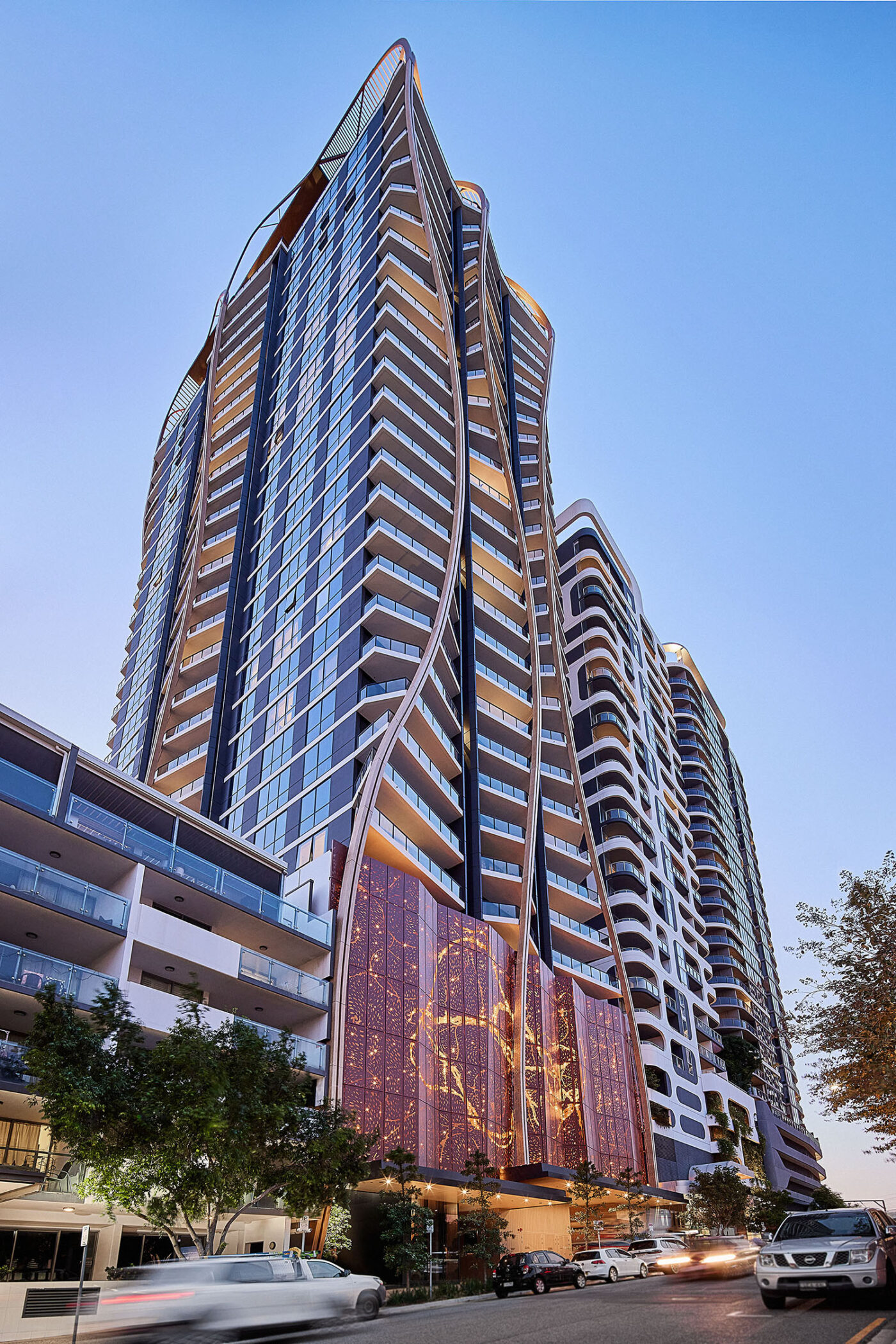View looking up at an Icon residential tower against a blue sky