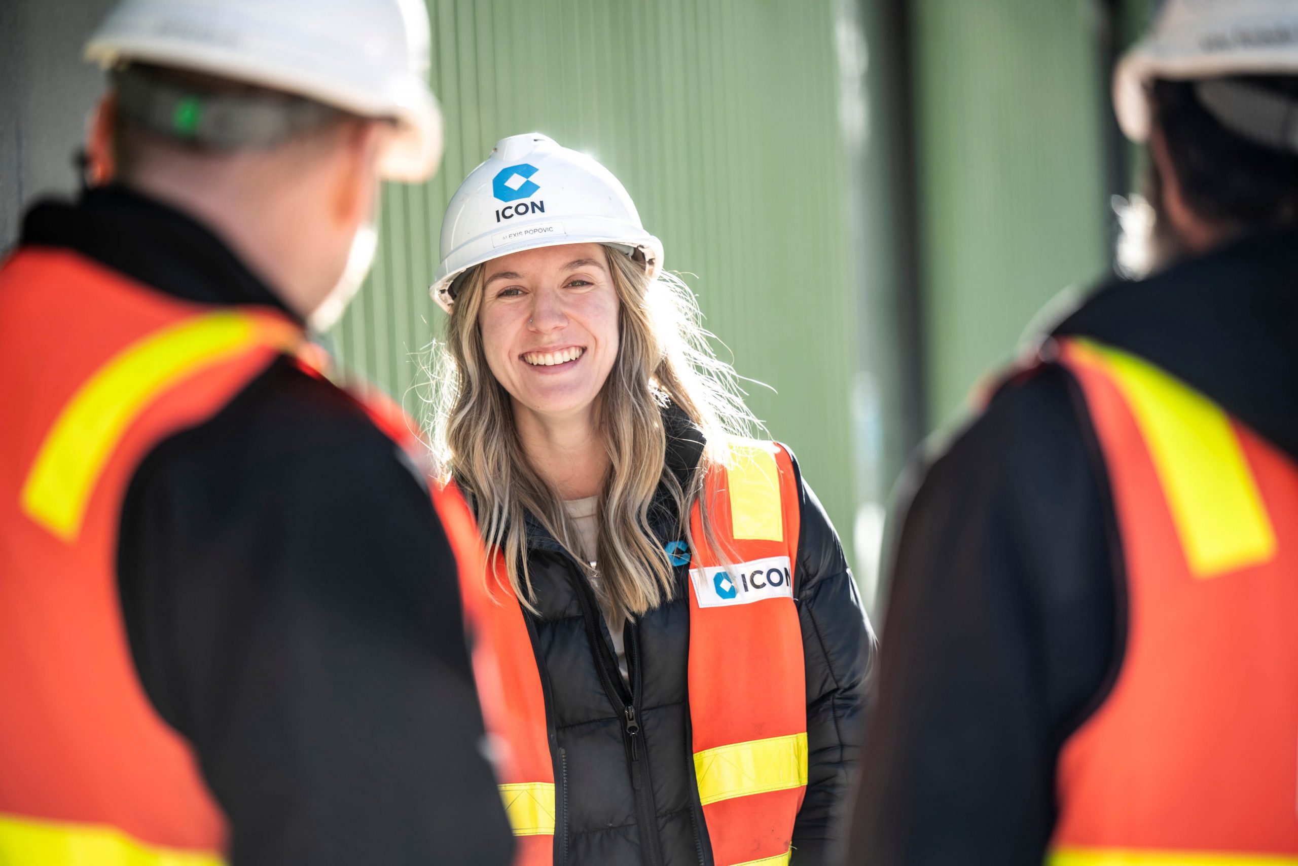 An Icon team member talking with colleagues on site