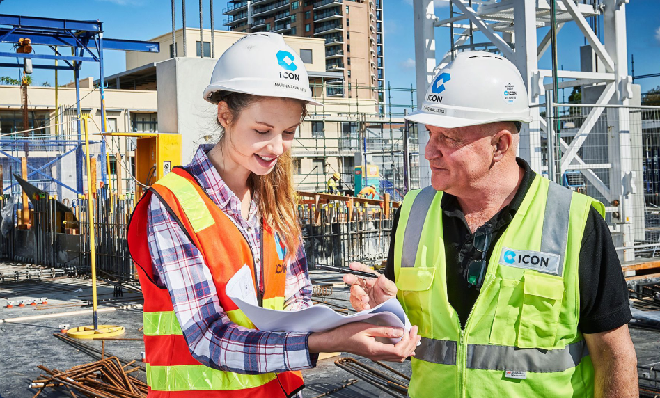 Two Icon site engineers reviewing plans together on site