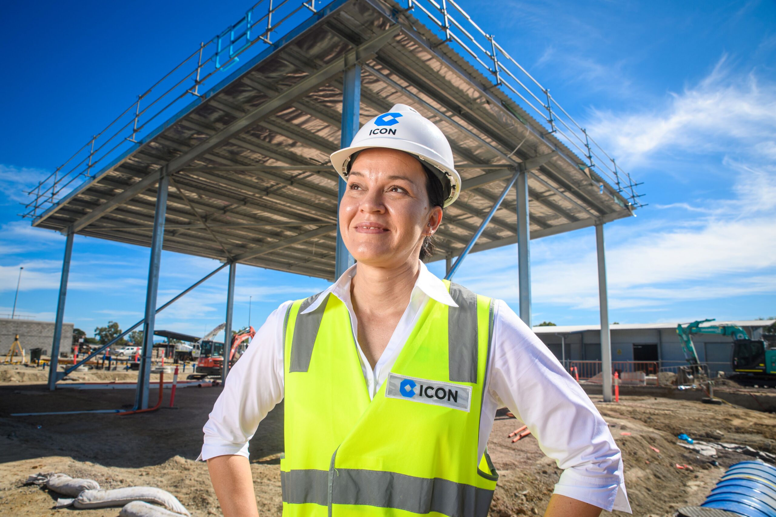 An Icon site team member in a hard hat and hi-vis on site