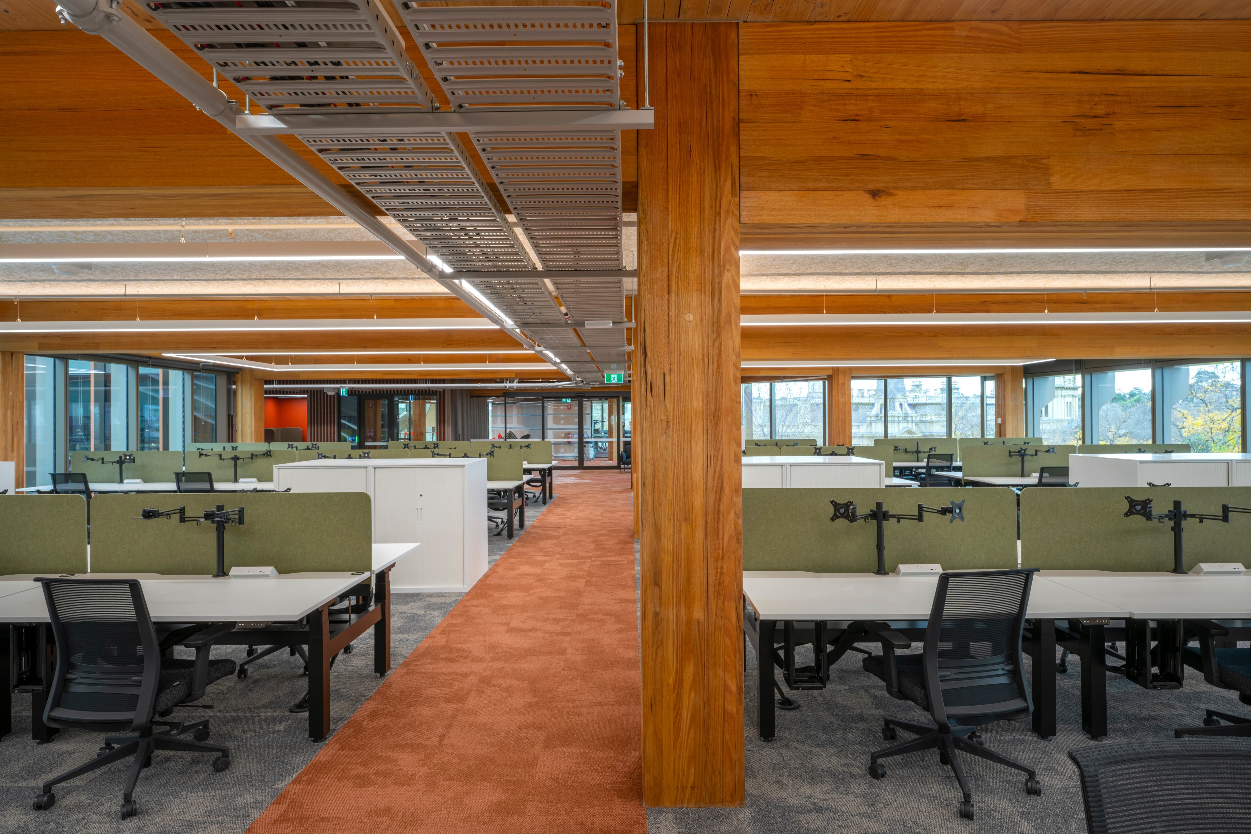 Open-plan workspace beneath the building's mass timber structure